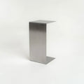 Monolith steel side table with bold minimal design, precision-cut metal construction, industrial bedside table for modern living room or bedroom
