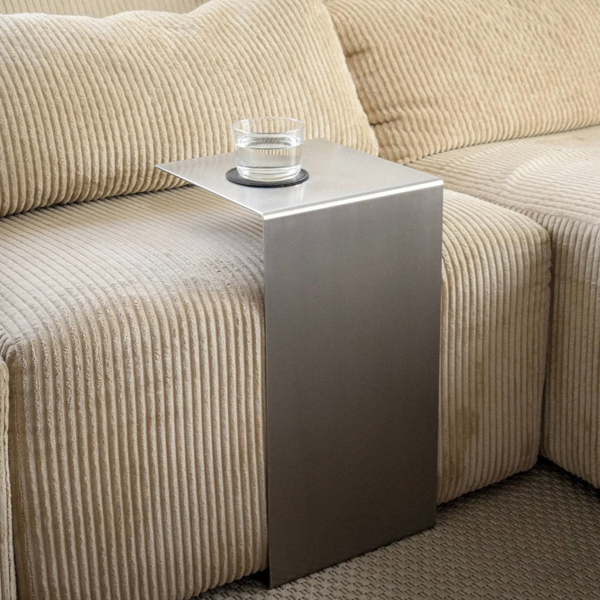Monolith steel side table with bold minimal design, precision-cut metal construction, industrial bedside table for modern living room or bedroom