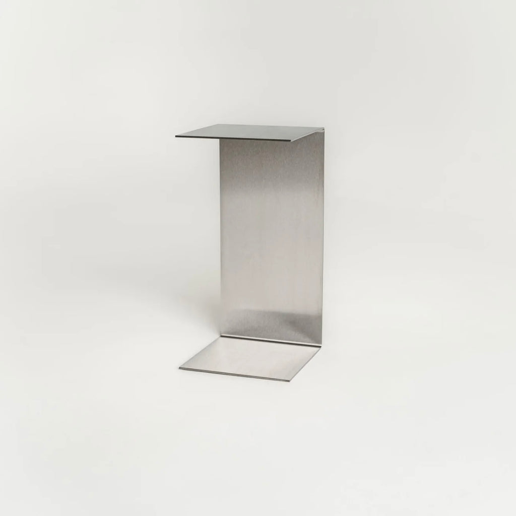 Monolith steel side table with bold minimal design, precision-cut metal construction, industrial bedside table for modern living room or bedroom