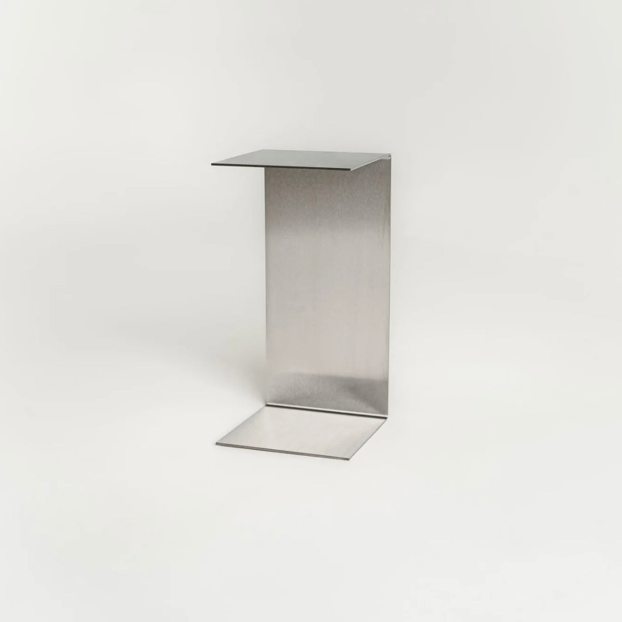 Monolith steel side table with bold minimal design, precision-cut metal construction, industrial bedside table for modern living room or bedroom