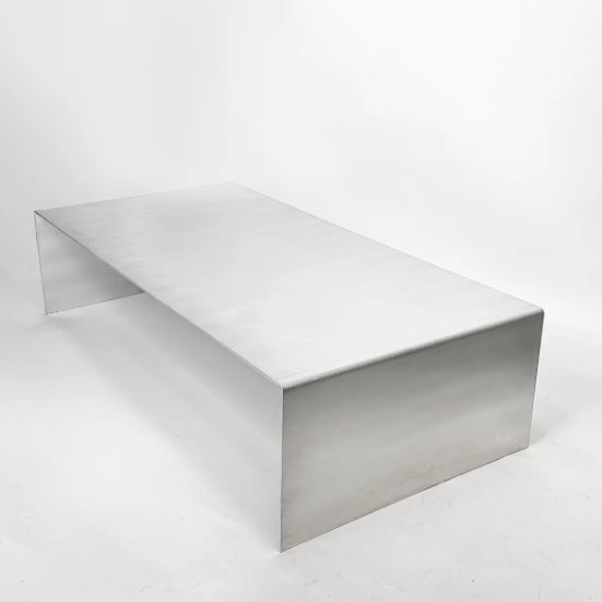 Monolith steel coffee table with bold minimal design, precision-cut metal construction, industrial center table for modern living room