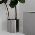 Minimal steel metal flower pot with clean industrial design, durable precision-formed construction, modern planter for indoor plants and contemporary interiors
