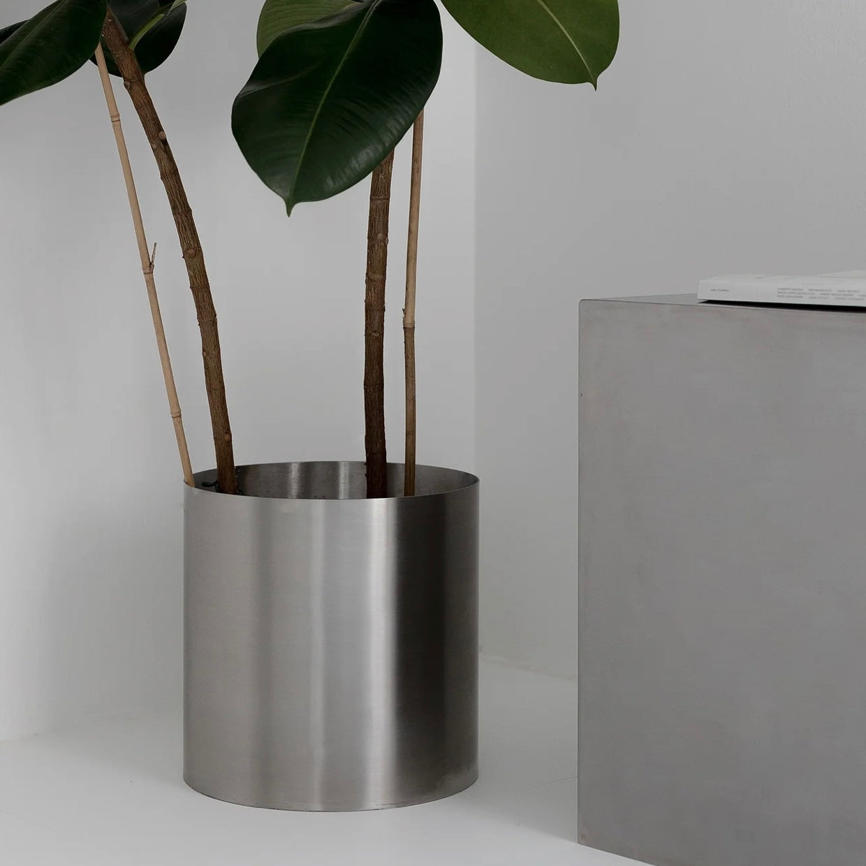 Minimal steel metal flower pot with clean industrial design, durable precision-formed construction, modern planter for indoor plants and contemporary interiors
