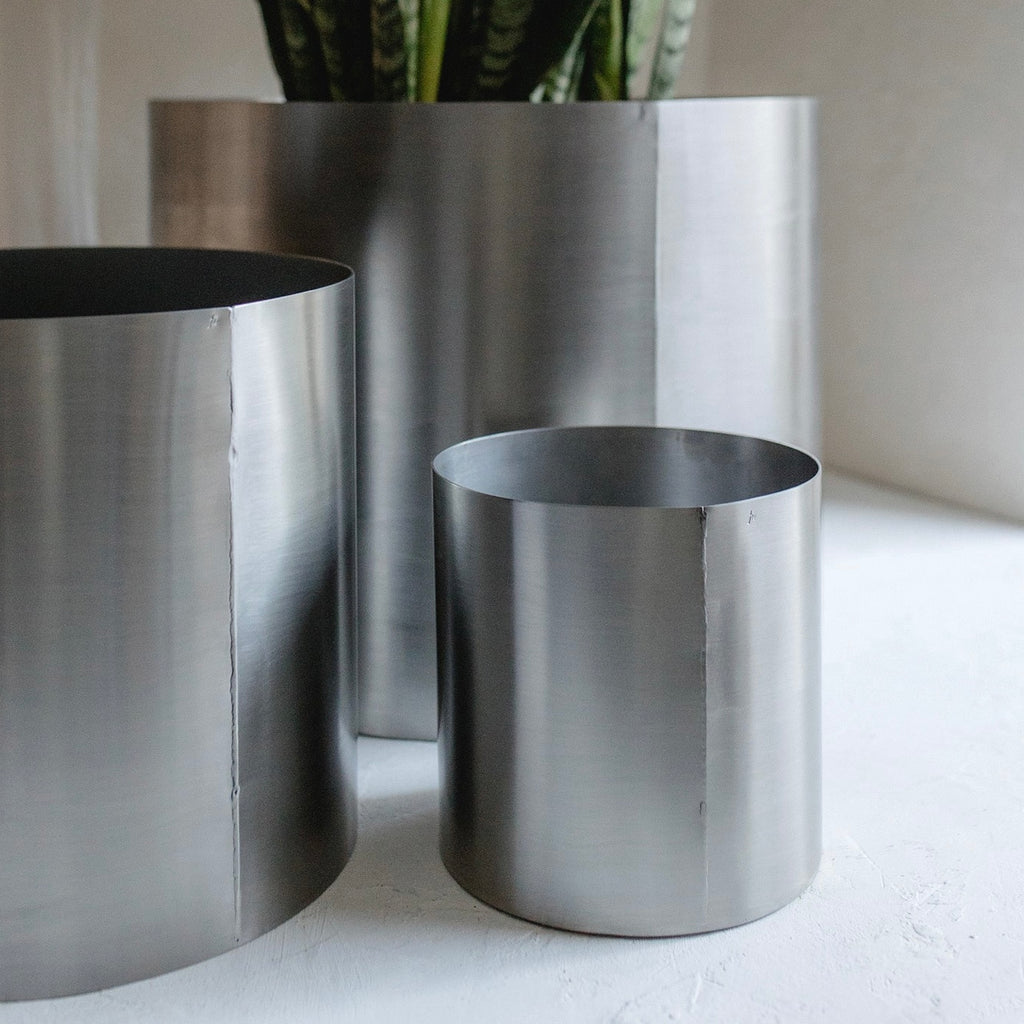 Minimal steel metal flower pot with clean industrial design, durable precision-formed construction, modern planter for indoor plants and contemporary interiors
