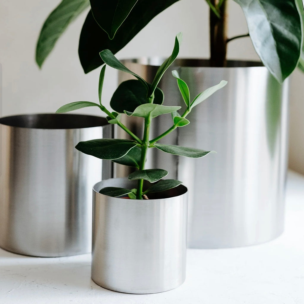 Minimal steel metal flower pot with clean industrial design, durable precision-formed construction, modern planter for indoor plants and contemporary interiors

