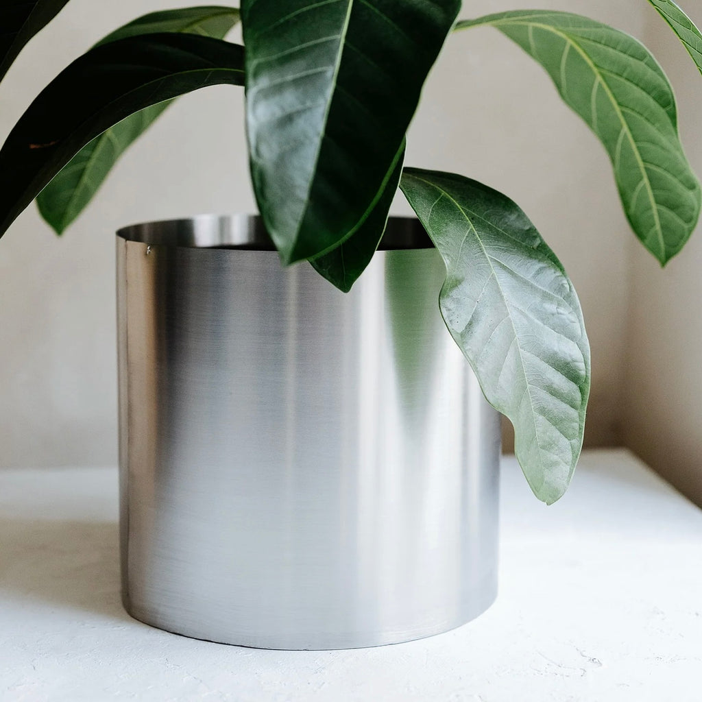 Minimal steel metal flower pot with clean industrial design, durable precision-formed construction, modern planter for indoor plants and contemporary interiors
