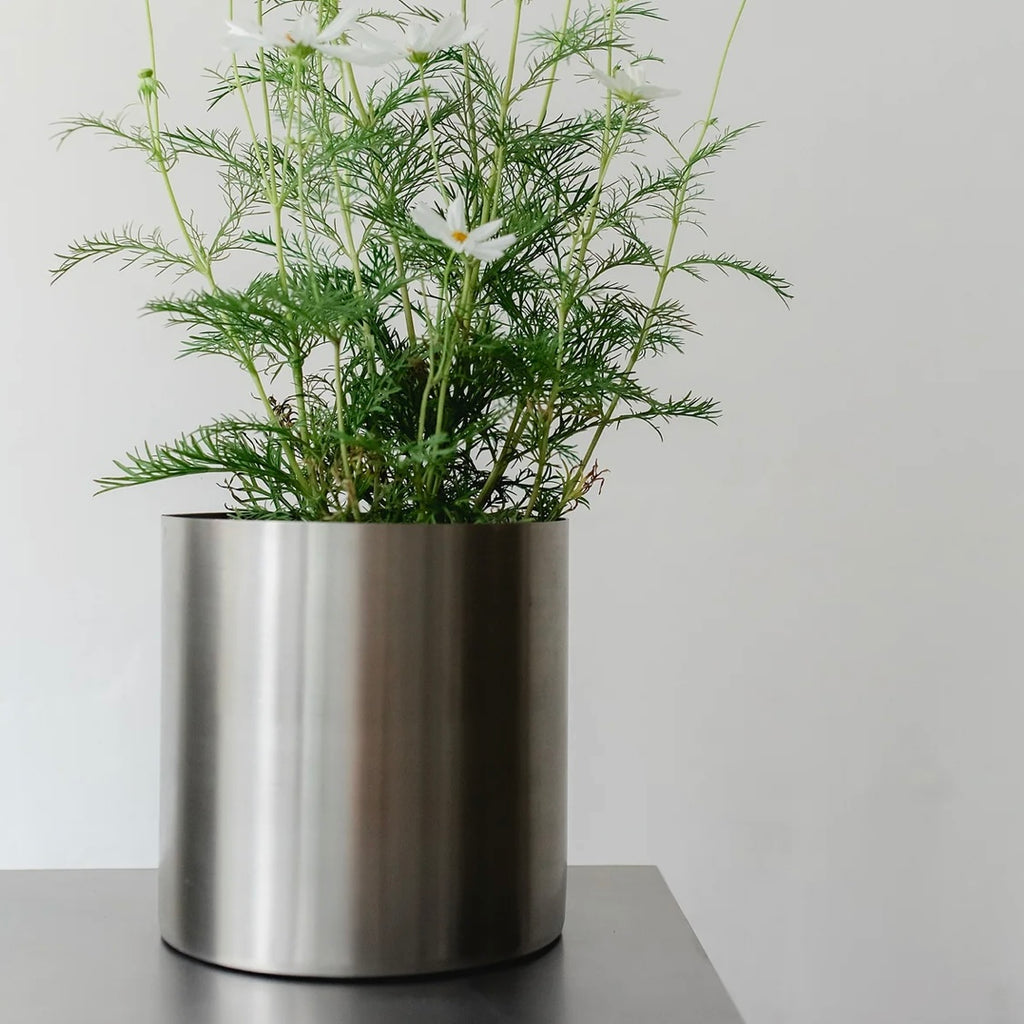 Minimal steel metal flower pot with clean industrial design, durable precision-formed construction, modern planter for indoor plants and contemporary interiors
