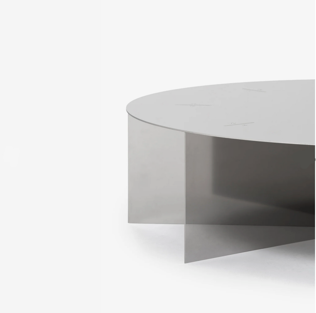 Radial steel coffee table with round top and geometric base design, precision-cut metal construction, minimal industrial center table for living room