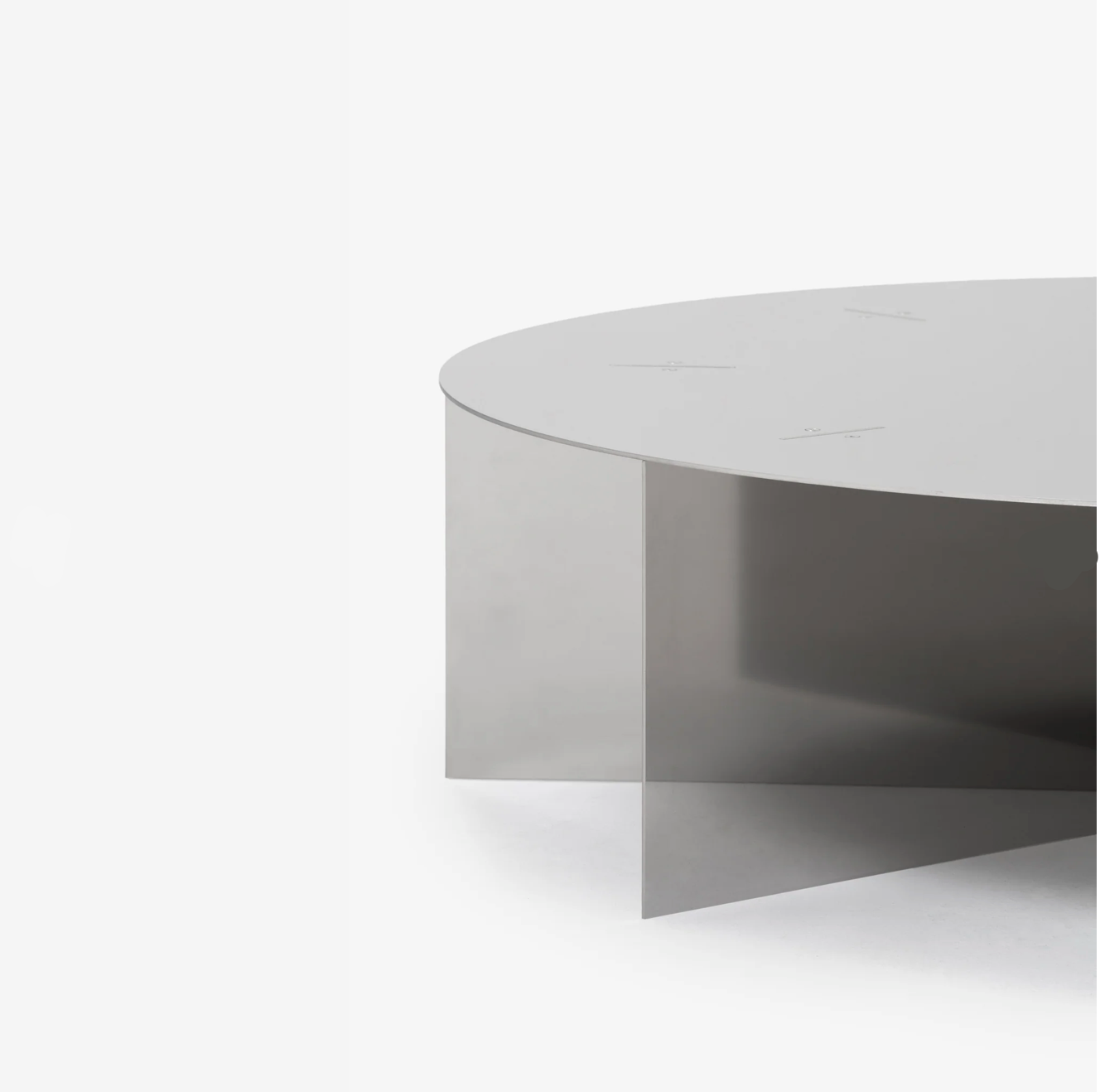 Radial steel coffee table with round top and geometric base design, precision-cut metal construction, minimal industrial center table for living room