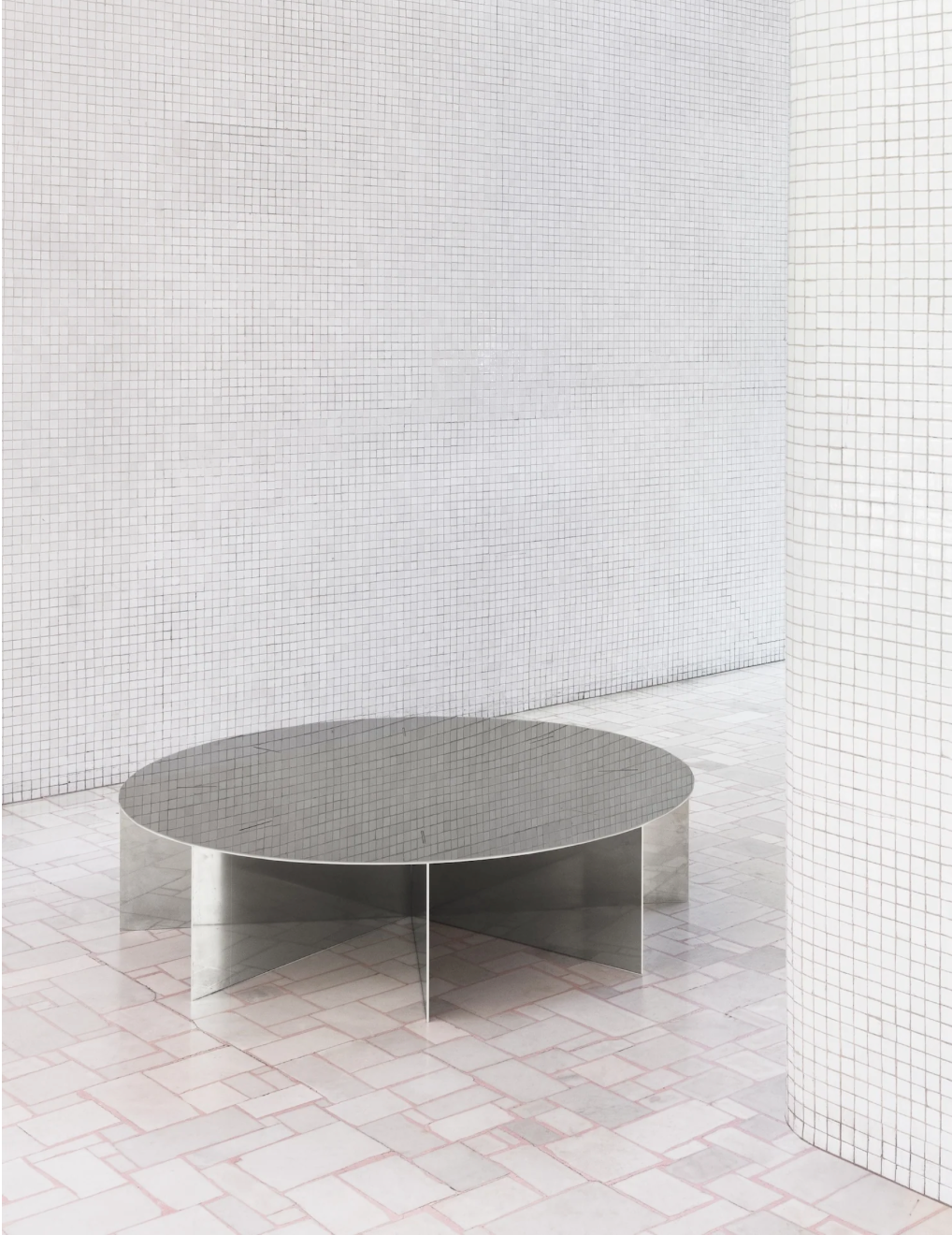 Radial steel coffee table with round top and geometric base design, precision-cut metal construction, minimal industrial center table for living room
