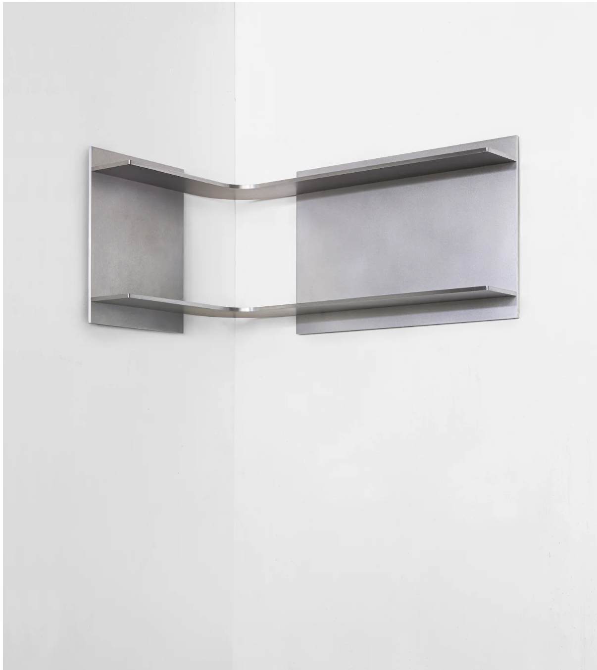 Metallic corner shelf mounted on a white wall